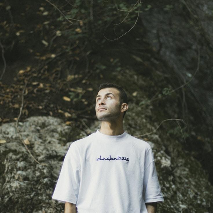 Alexandra Kim, Lead Design Curator at GardenVoyantBridge, reviewing corporate floral arrangements